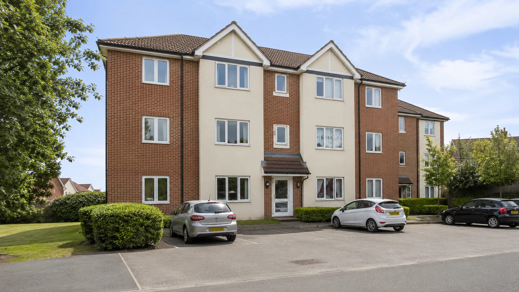 A well-maintained British residential block with landscaped frontage
